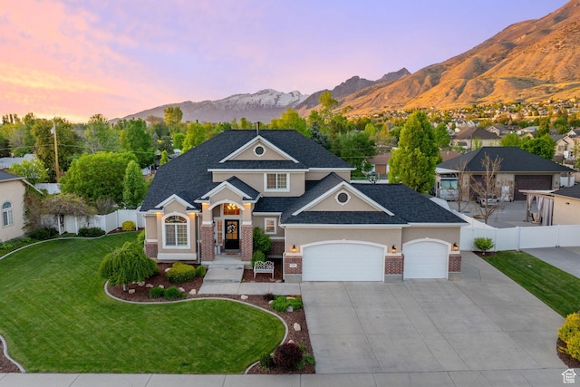 512 Glendon Way, Pleasant Grove, UT 84062 - view of front of home featuring brick siding, a garage, concrete driveway, a mountain view, and roof with shingles