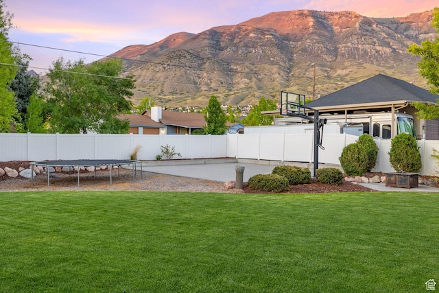 512 Glendon Way, Pleasant Grove, UT 84062 - yard at dusk featuring a mountain view, a gazebo, and a trampoline
