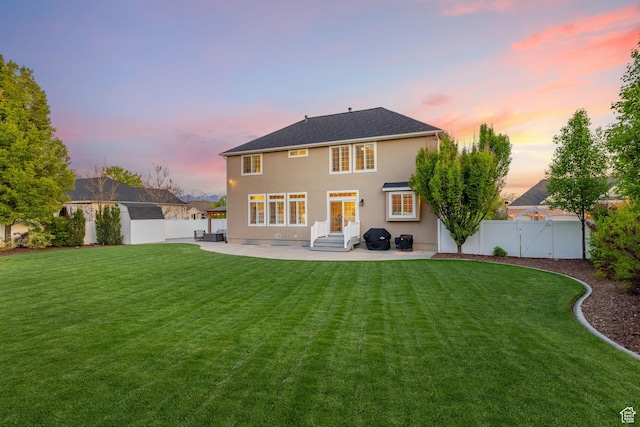 512 Glendon Way, Pleasant Grove, UT 84062 - back of house at dusk featuring a patio, a gate, stucco siding, and entry steps