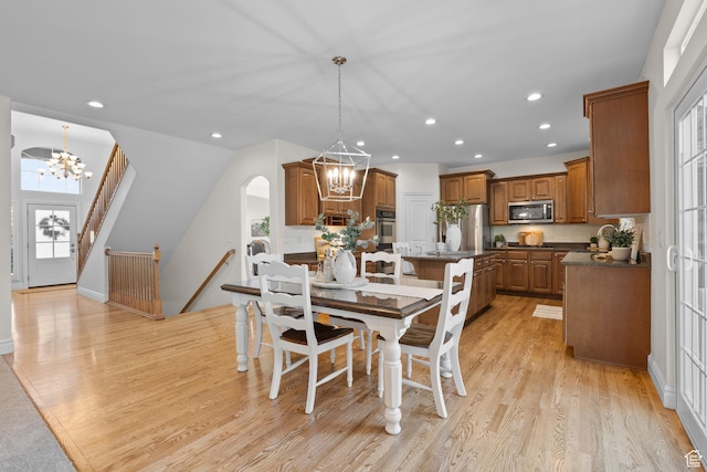 512 Glendon Way, Pleasant Grove, UT 84062 - dining area featuring a chandelier, healthy amount of natural light, recessed lighting, light wood finished floors, and arched walkways