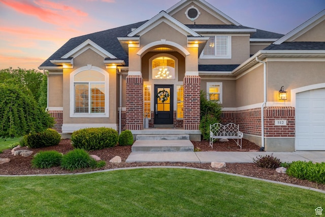 512 Glendon Way, Pleasant Grove, UT 84062 - entrance to property featuring stucco siding, a yard, brick siding, and a shingled roof