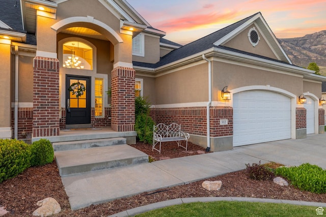 512 Glendon Way, Pleasant Grove, UT 84062 - view of front facade featuring brick siding, stucco siding, driveway, and a garage
