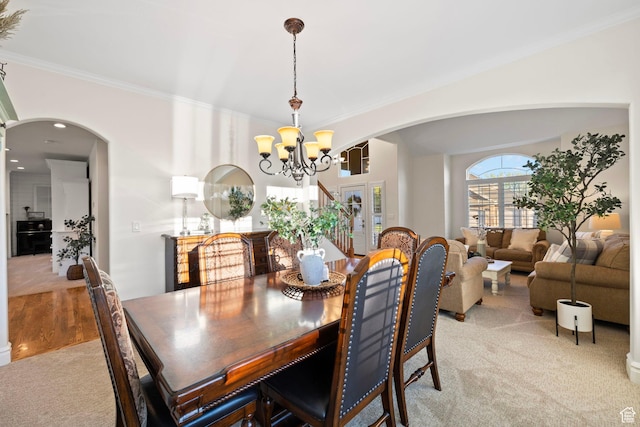 512 Glendon Way, Pleasant Grove, UT 84062 - dining room with light carpet, a chandelier, arched walkways, and ornamental molding