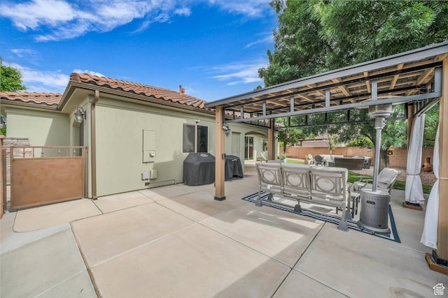 view of patio / terrace with an outdoor living space, fence, grilling area, and a gazebo
