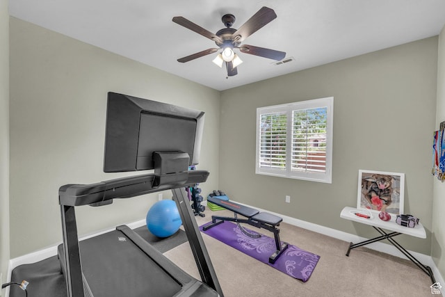 exercise room with ceiling fan, baseboards, and carpet