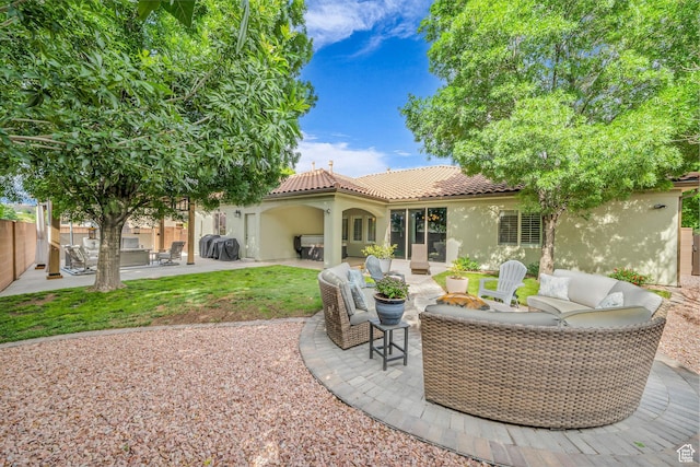 1492 S Carma St, Washington, UT 84780 - back of property with stucco siding, outdoor lounge area, a tiled roof, and a patio