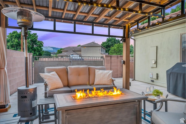 view of patio / terrace featuring an outdoor fire pit, fence, and grilling area