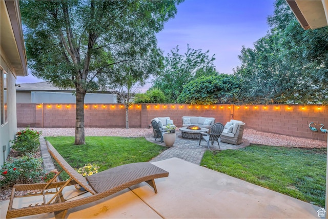 patio terrace at dusk with an outdoor living space with a fire pit