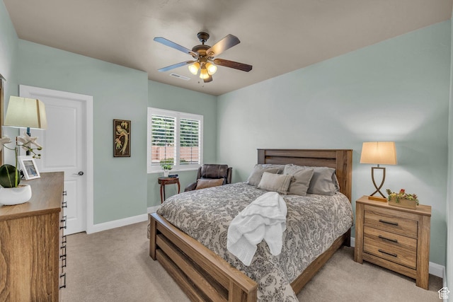 bedroom featuring light carpet, baseboards, and a ceiling fan