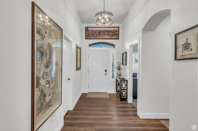 1492 S Carma St, Washington, UT 84780 - foyer entrance with dark wood finished floors, a chandelier, and arched walkways