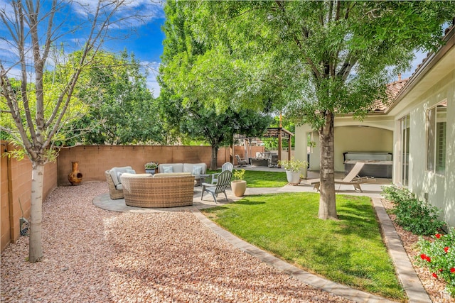 fenced backyard with an outdoor living space and a patio