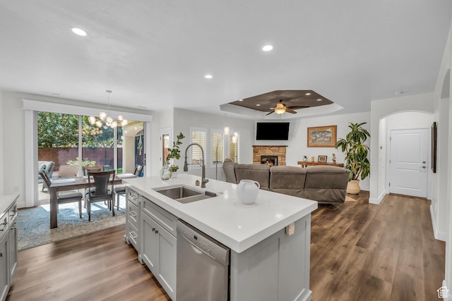 1492 S Carma St, Washington, UT 84780 - kitchen featuring stainless steel dishwasher, a stone fireplace, light countertops, a raised ceiling, and recessed lighting