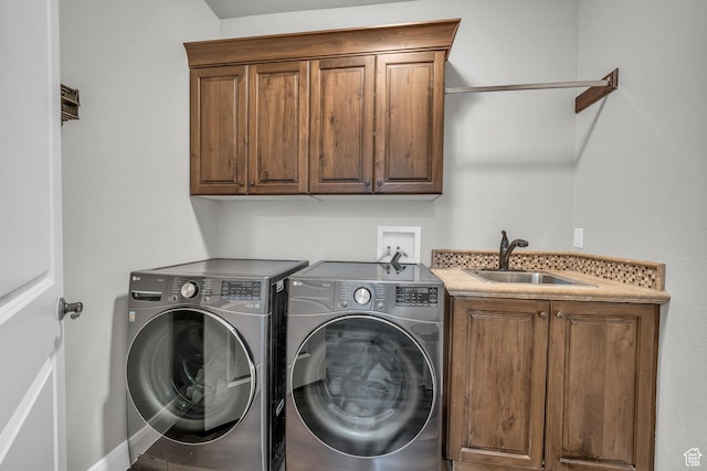 washroom with cabinet space and washing machine and dryer