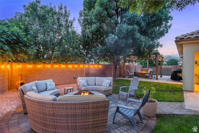 view of patio featuring an outdoor living space with a fire pit and a fenced backyard