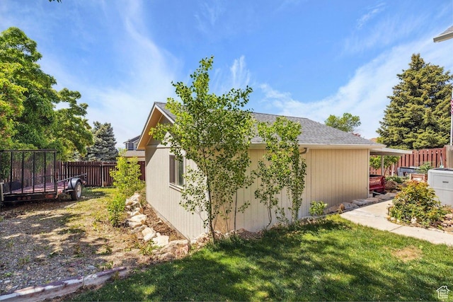 view of side of property featuring a shingled roof