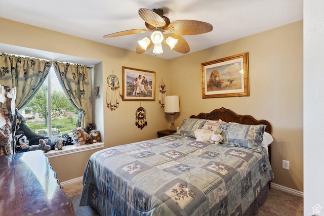 carpeted bedroom with baseboards and ceiling fan
