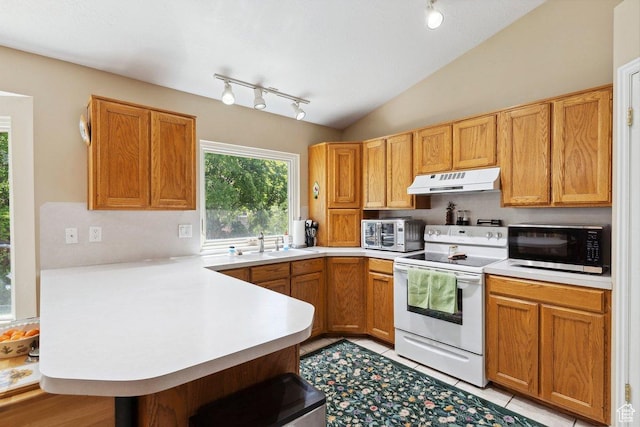 kitchen with white range with electric cooktop, track lighting, a peninsula, under cabinet range hood, and lofted ceiling