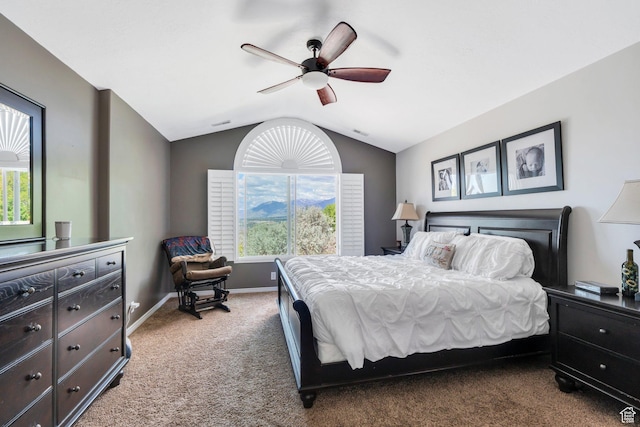 carpeted bedroom with lofted ceiling, baseboards, and a ceiling fan