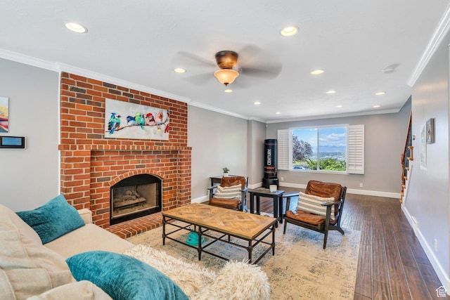 living area with baseboards, recessed lighting, ornamental molding, wood finished floors, and a fireplace