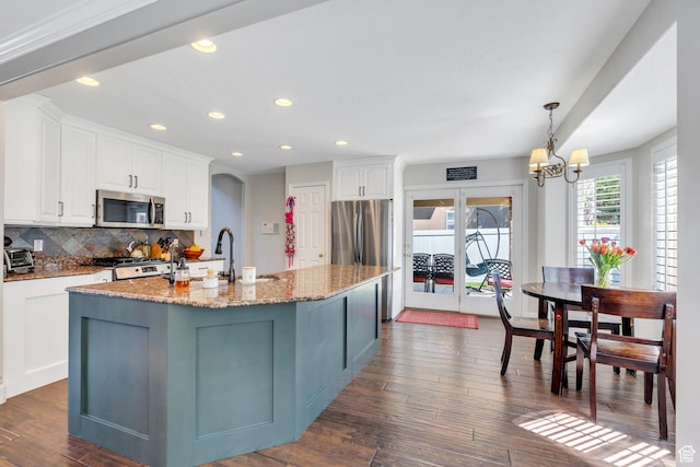 kitchen with stainless steel appliances, tasteful backsplash, recessed lighting, white cabinetry, and dark wood finished floors