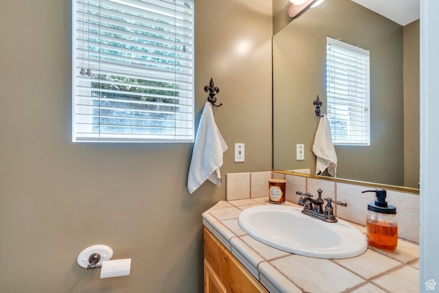 bathroom with plenty of natural light and vanity