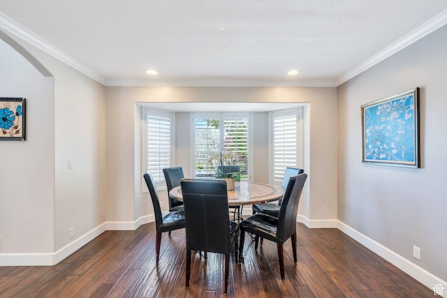 dining space with dark wood-style flooring, ornamental molding, baseboards, recessed lighting, and arched walkways