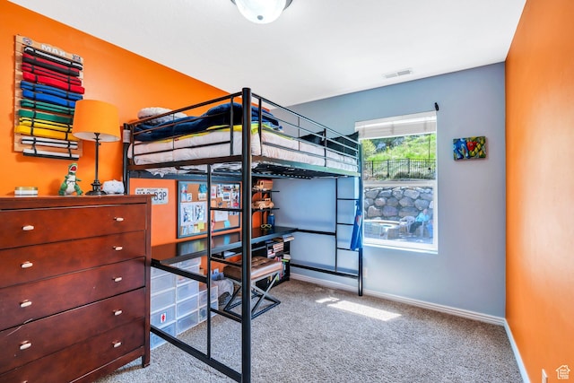 bedroom with carpet flooring and baseboards