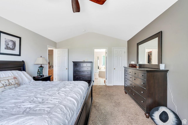 bedroom featuring vaulted ceiling, light carpet, ensuite bath, and ceiling fan