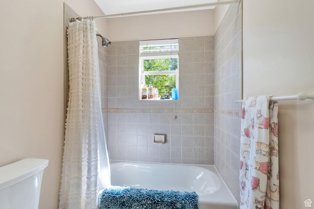 bathroom with toilet and shower / tub combo