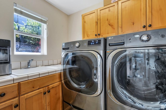 laundry room with cabinet space and independent washer and dryer