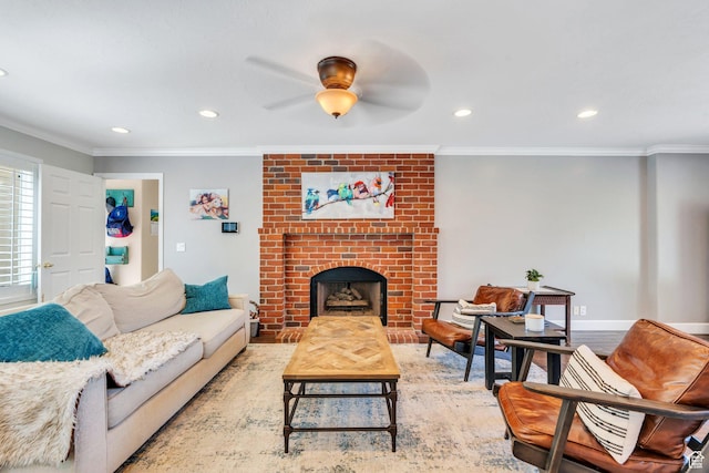 living area featuring ceiling fan, a brick fireplace, recessed lighting, and crown molding
