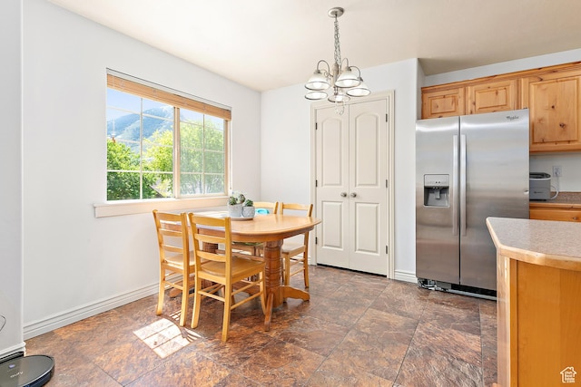 3123 E Canyon Glen Loop S, Spanish Fork, UT 84660 - dining space featuring a chandelier, dark stone finish floors, and baseboards