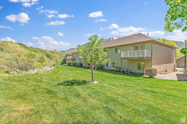 3123 E Canyon Glen Loop S, Spanish Fork, UT 84660 - back of house featuring a yard, a balcony, and stucco siding