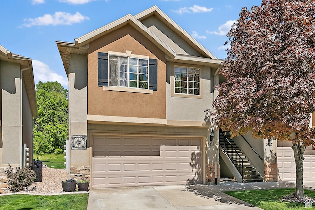 3123 E Canyon Glen Loop S, Spanish Fork, UT 84660 - view of front facade featuring stucco siding, a garage, concrete driveway, and stairs