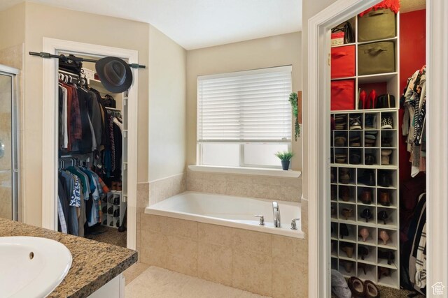 1768 N 200 W, North Ogden, UT 84414 - bathroom featuring a spacious closet, a shower stall, a bath, and vanity