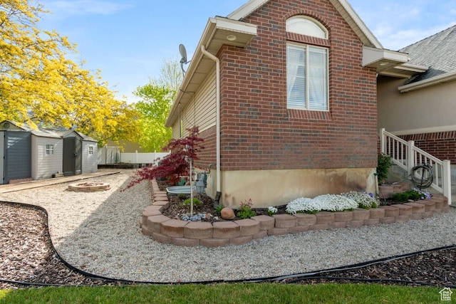 1768 N 200 W, North Ogden, UT 84414 - view of property exterior with brick siding, a shed, and an outdoor structure