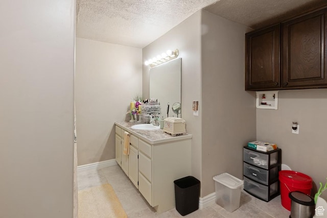 1768 N 200 W, North Ogden, UT 84414 - bathroom with a textured ceiling, vanity, and baseboards