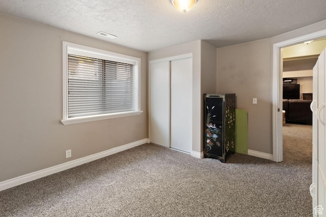 1768 N 200 W, North Ogden, UT 84414 - unfurnished bedroom with carpet flooring, a textured ceiling, a closet, and baseboards