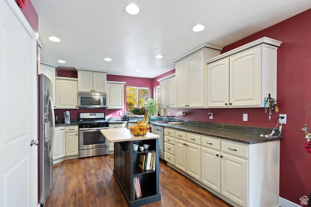 1768 N 200 W, North Ogden, UT 84414 - kitchen featuring appliances with stainless steel finishes, dark wood finished floors, dark countertops, and recessed lighting