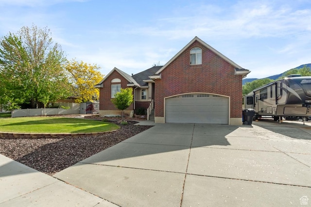 1768 N 200 W, North Ogden, UT 84414 - view of front of property with an attached garage, concrete driveway, brick siding, and a mountain view