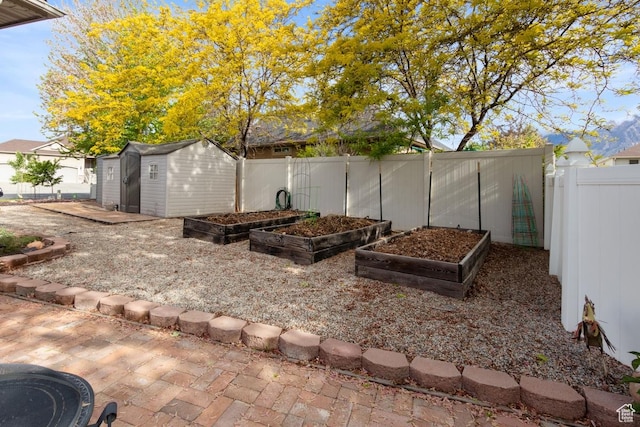 1768 N 200 W, North Ogden, UT 84414 - fenced backyard featuring a garden, a storage unit, and an outbuilding
