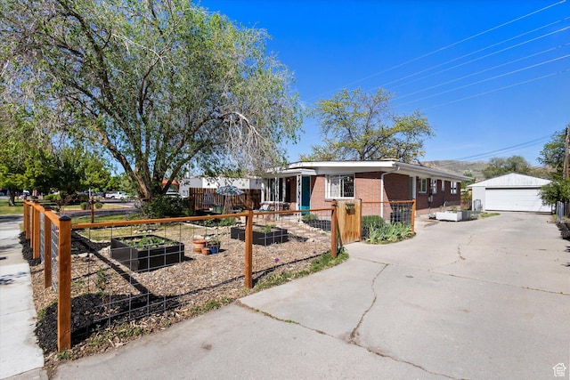 944 N 1400 W, Salt Lake City, UT 84116 - single story home with a vegetable garden, brick siding, a garage, a fenced front yard, and an outdoor structure