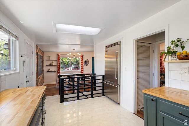 944 N 1400 W, Salt Lake City, UT 84116 - kitchen featuring butcher block counters, built in refrigerator, and a chandelier