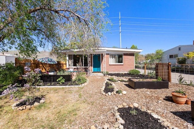 944 N 1400 W, Salt Lake City, UT 84116 - view of front of house with a garden, brick siding, and fence
