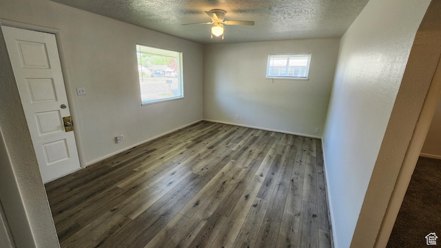 unfurnished room with wood-type flooring, a ceiling fan, a textured ceiling, and baseboards