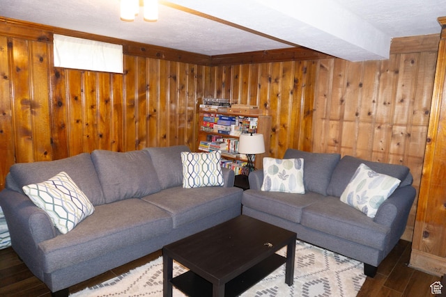 living area with wooden walls, wood finished floors, and a textured ceiling