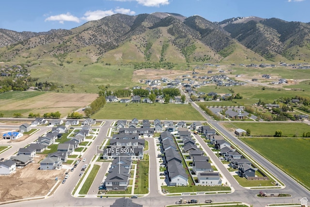 aerial view of property's location with nearby suburban area and a mountainous background