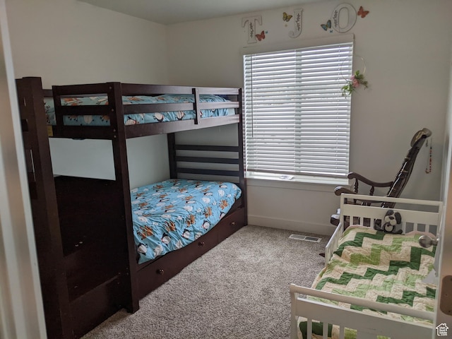 carpeted bedroom featuring baseboards