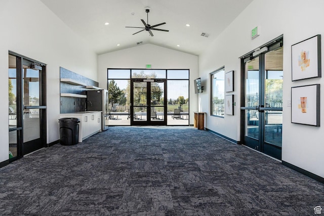 community lobby featuring high vaulted ceiling and recessed lighting