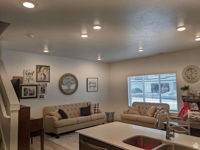 living area with light wood finished floors and recessed lighting
